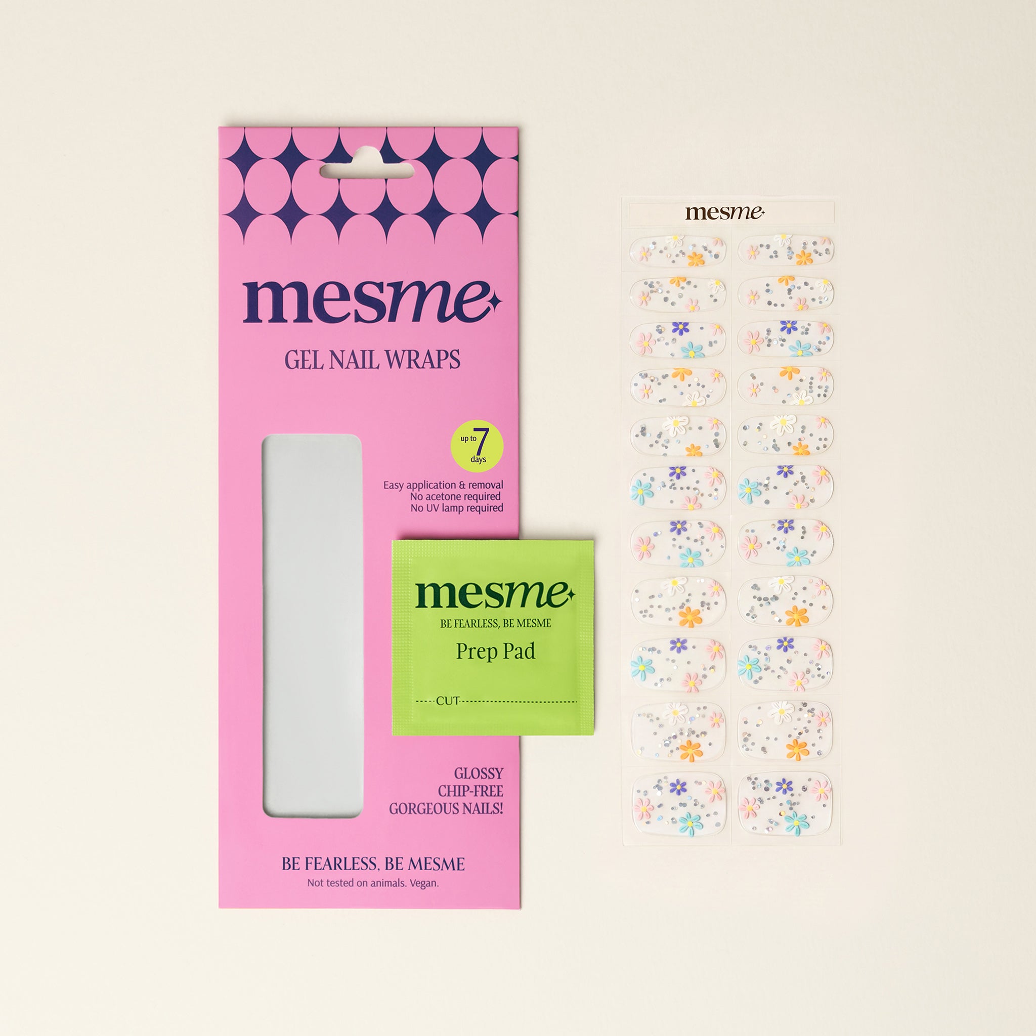 Clear mesme gel nail wraps with colourful daisy flowers, packaging and prep pad on a neutral background.