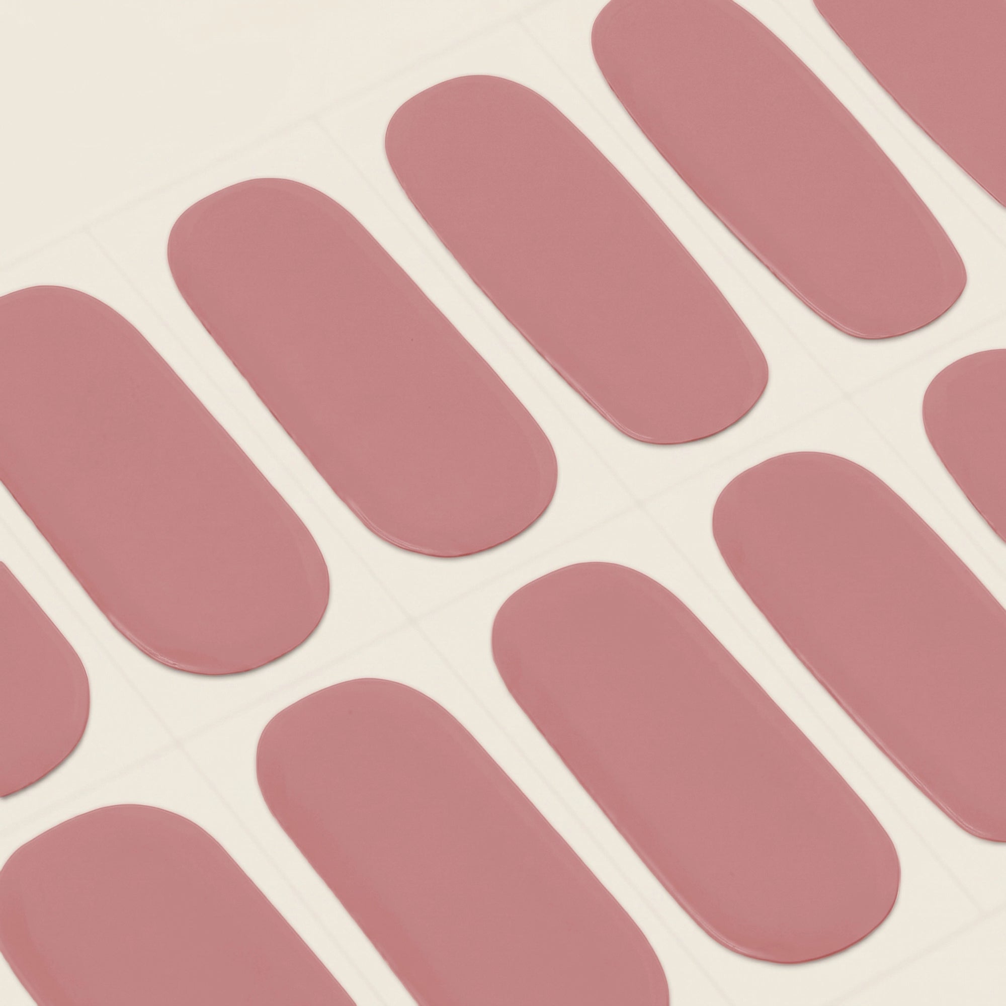 Close-up of mesme's Frankie STAY semi-cured gel nail wrap strips in a soft dusty rose pink shade.
