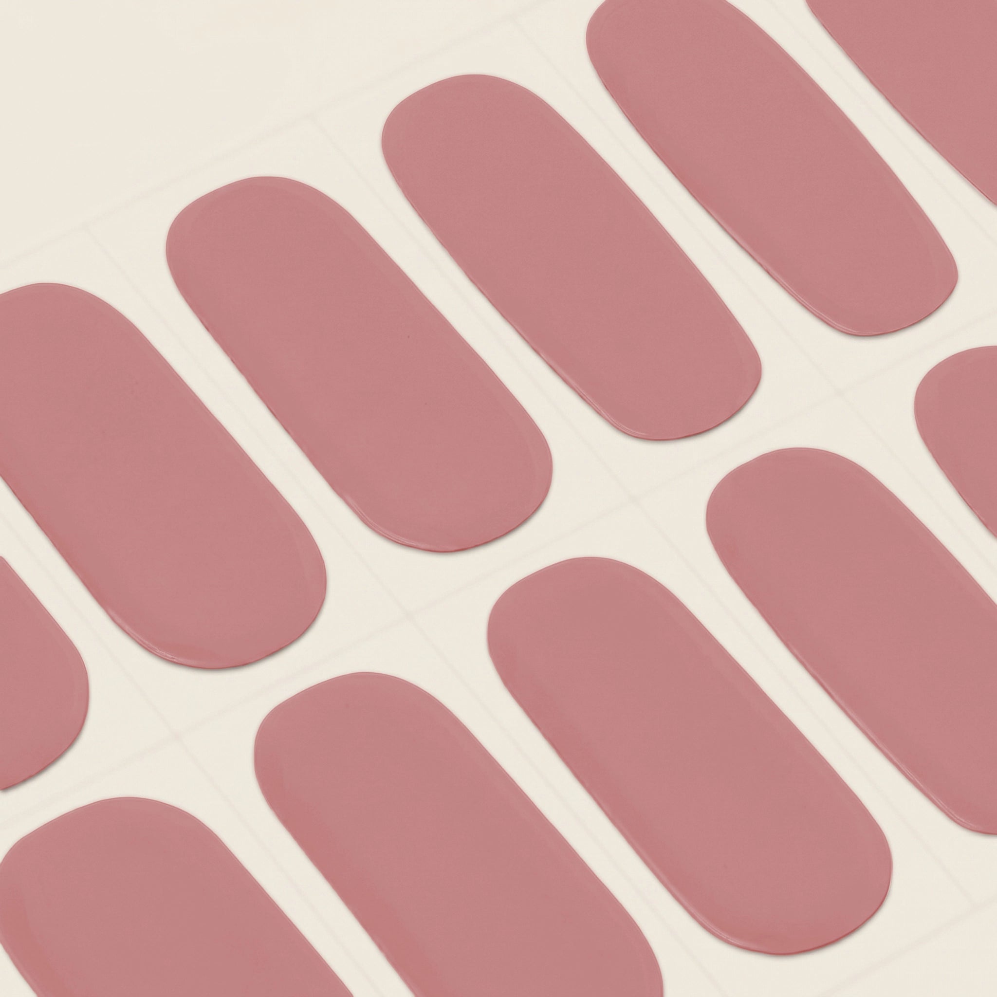 Close-up of mesme's Frankie STAY semi-cured gel nail wrap strips in a soft dusty rose pink shade.