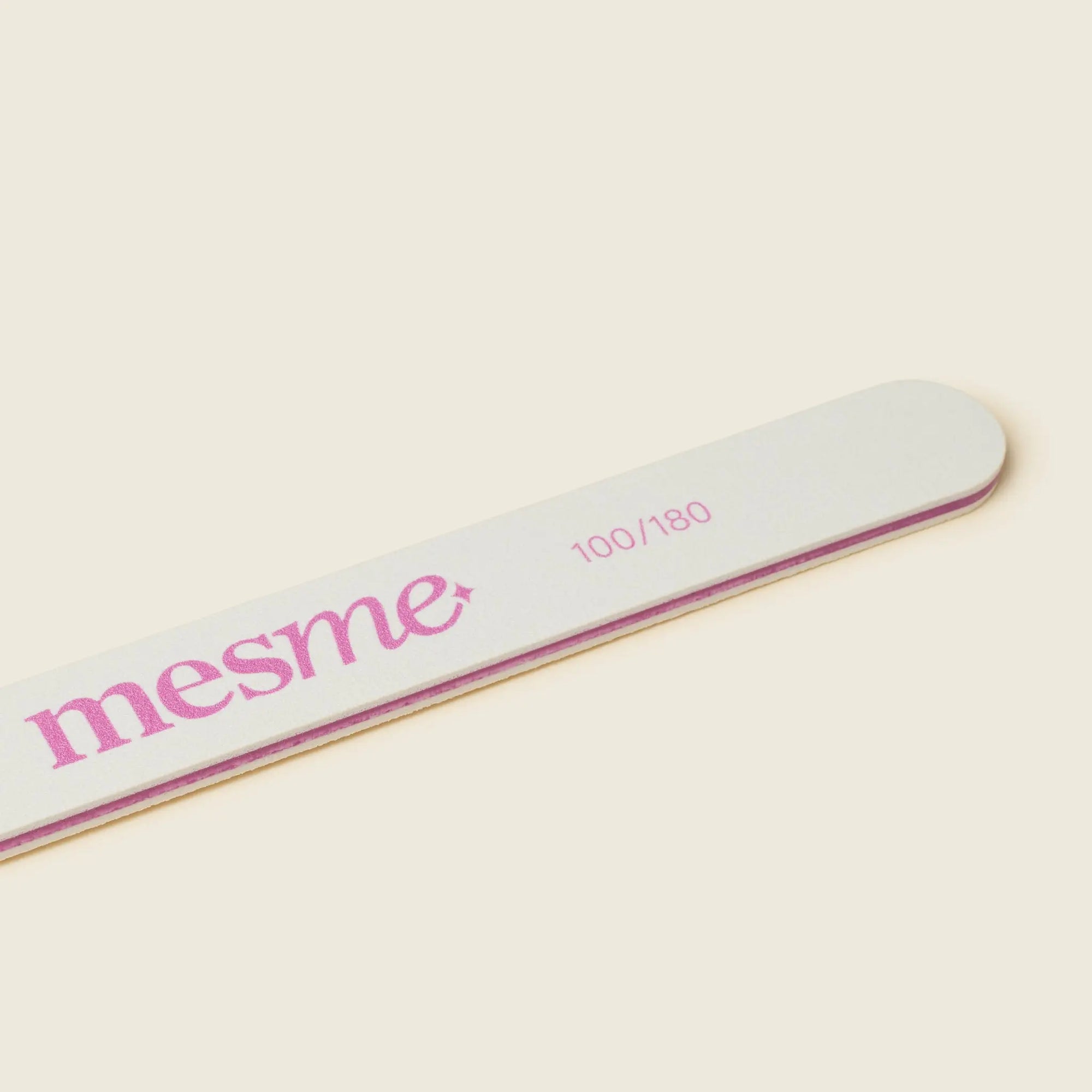 Angled close-up of the mesme fine-grit nail file, designed to smooth without damaging wraps.